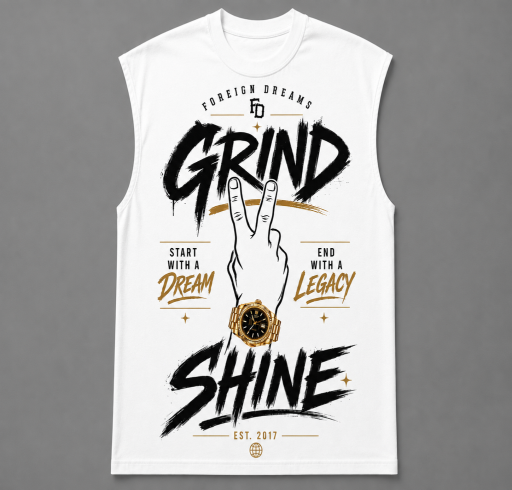A sleeveless white t-shirt with a graphic print featuring the words 'GRIND' and 'SHINE' in black brush lettering, a hand making a peace sign, a gold watch illustration, and motivational text on a gray background.